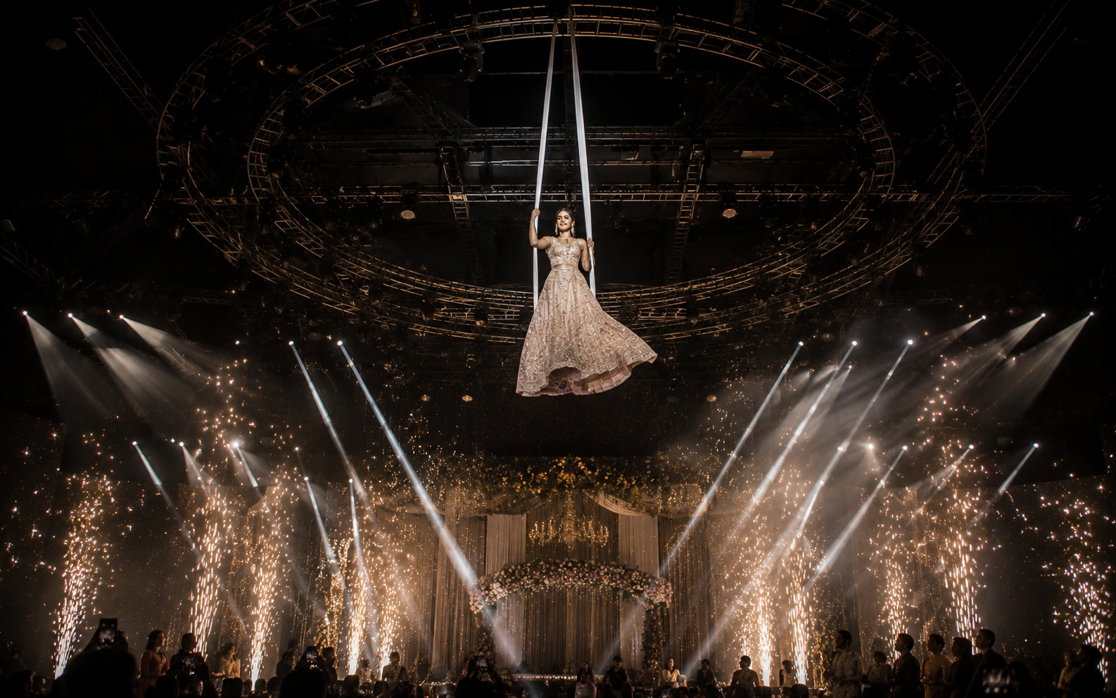 Breathtaking aerial silk performance and special effects production by Lotus Grandeure featuring cold spark fountains, professional rigging safety systems, and cinematic luxury wedding entertainment in India.