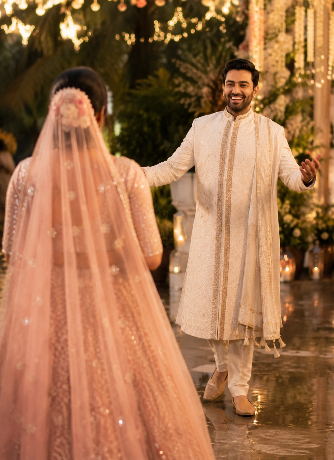 Romantic first look between an Indian bride and groom sharing an emotional pre-wedding moment surrounded by elegant floral décor at a luxury destination wedding.