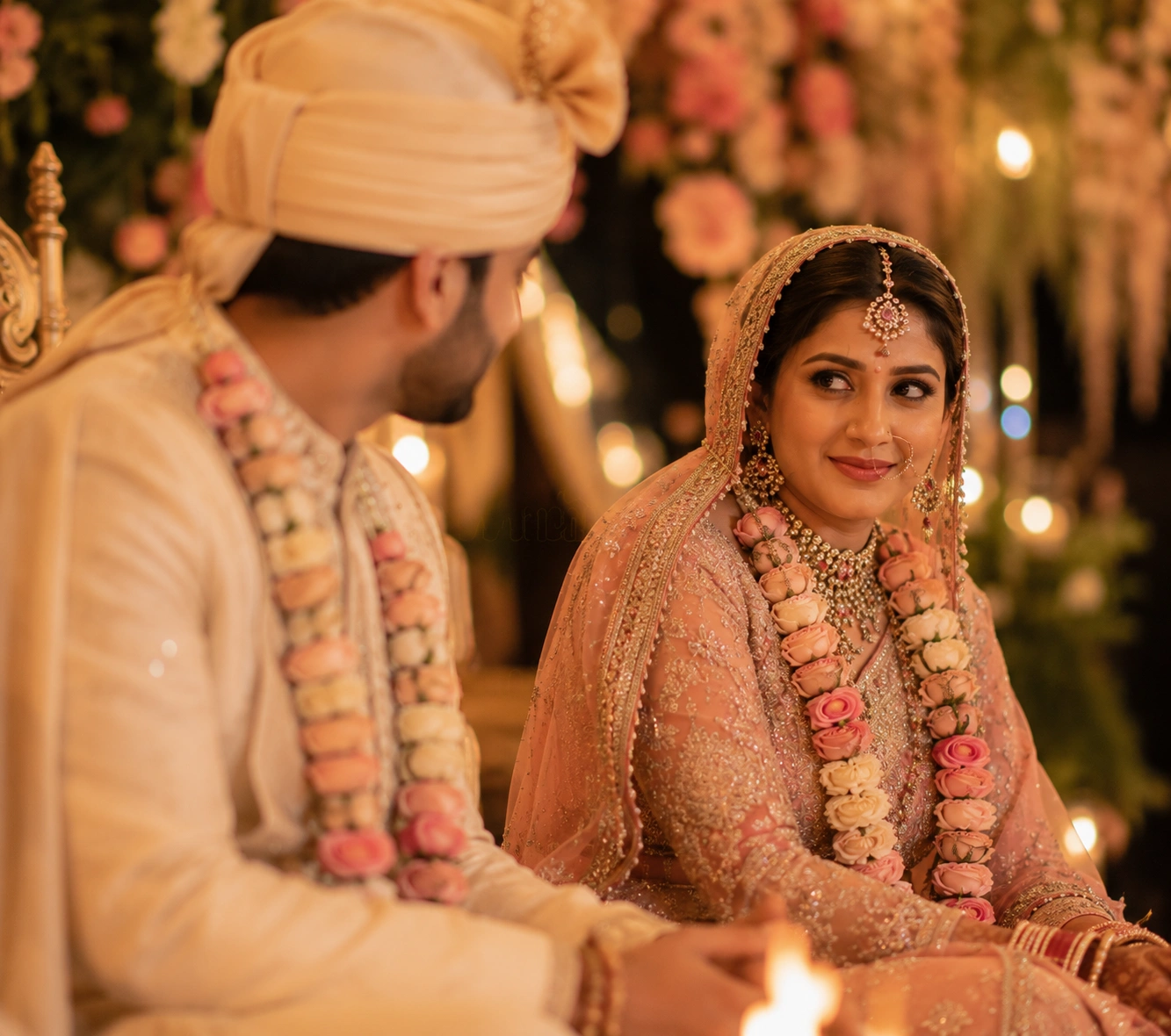 Intimate stolen glance between the Indian bride and groom capturing a romantic candid wedding moment during an elegant luxury destination wedding celebration.
